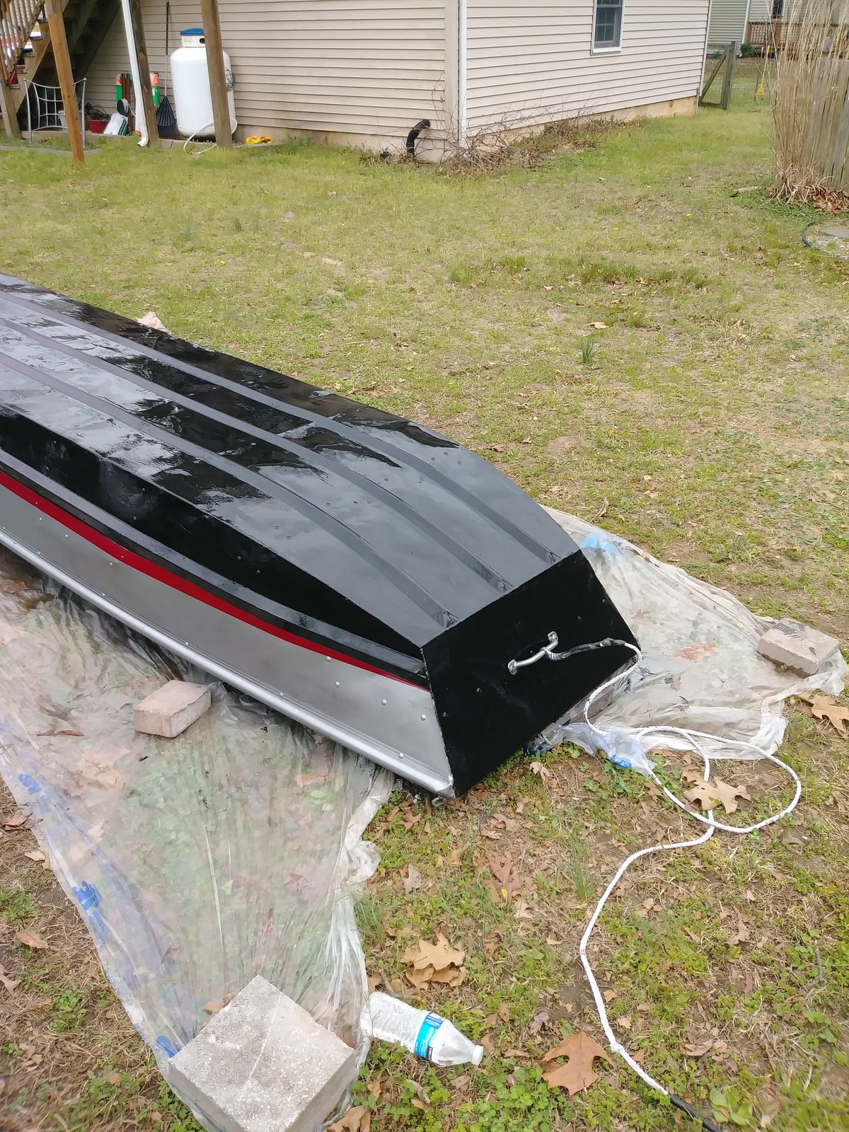 Close-up of the black-painted hull with red pinstripe